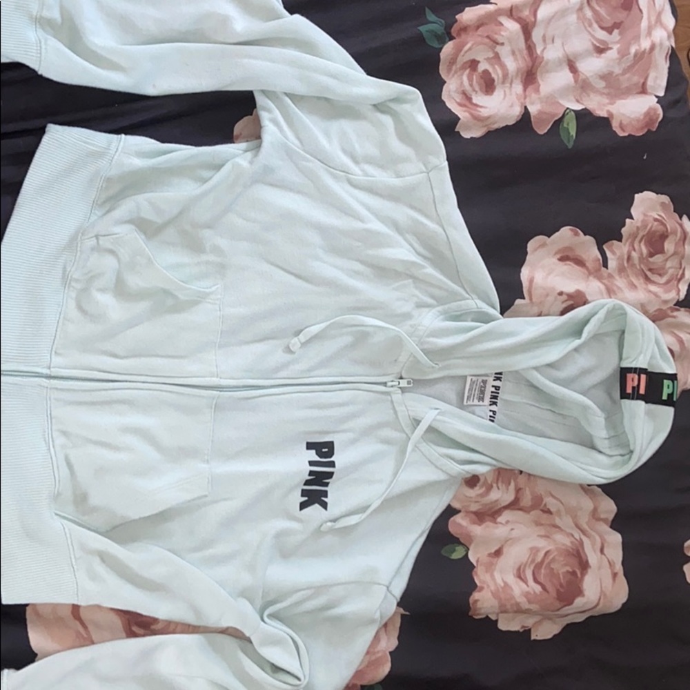 A mint colored PINK brand zip up jacket
